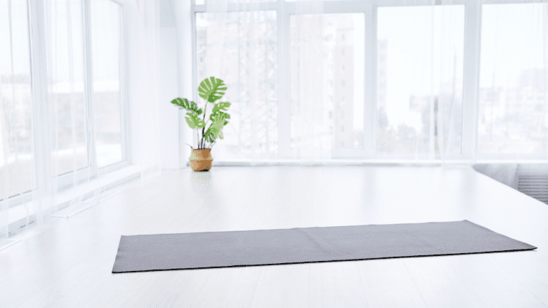 Yoga mat and plant in a white relaxing empty space